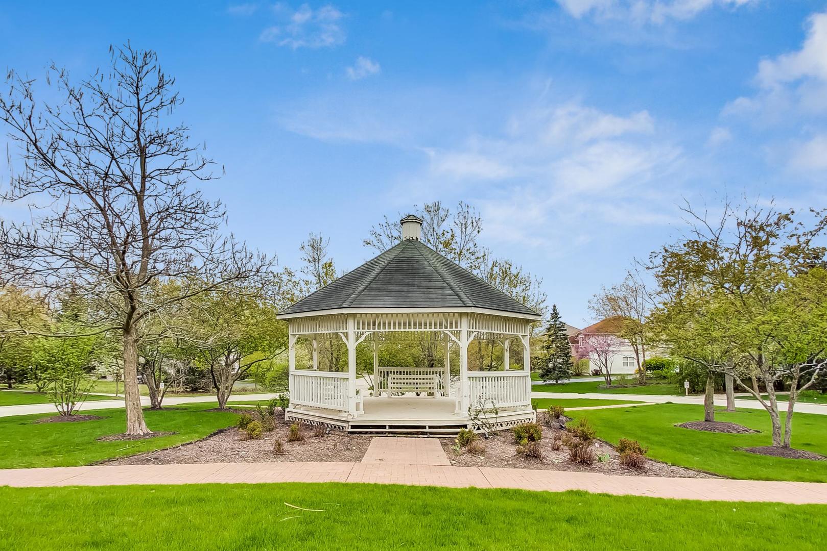 8052 Orchard Commons West Long Grove, IL 60060 - Photo 28 of 32 a white house with a big yard and large trees