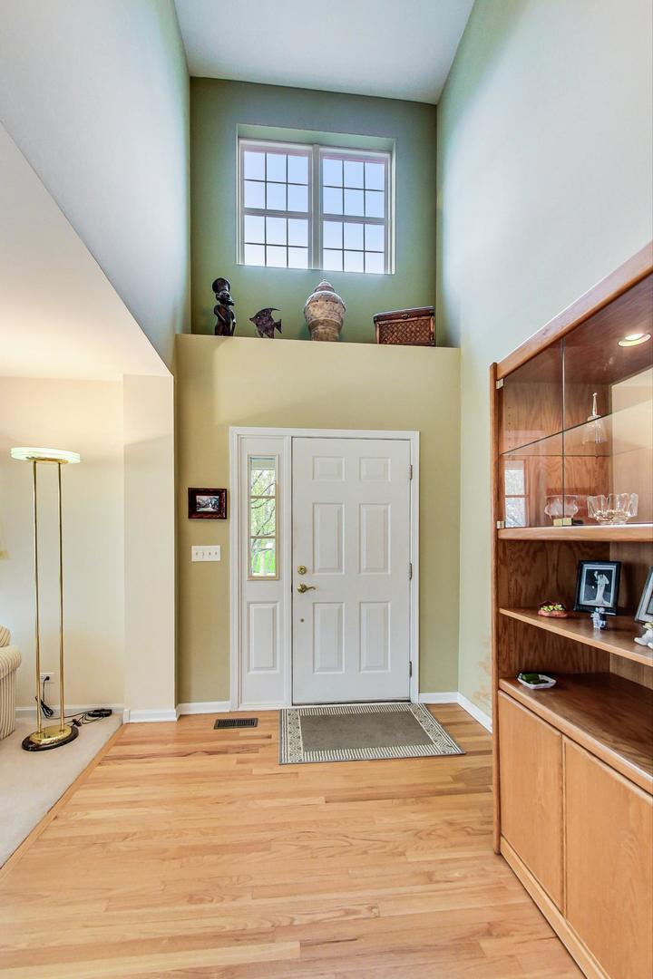 8052 Orchard Commons West Long Grove, IL 60060 - Photo 5 of 32 a view of a kitchen with kitchen island and windows