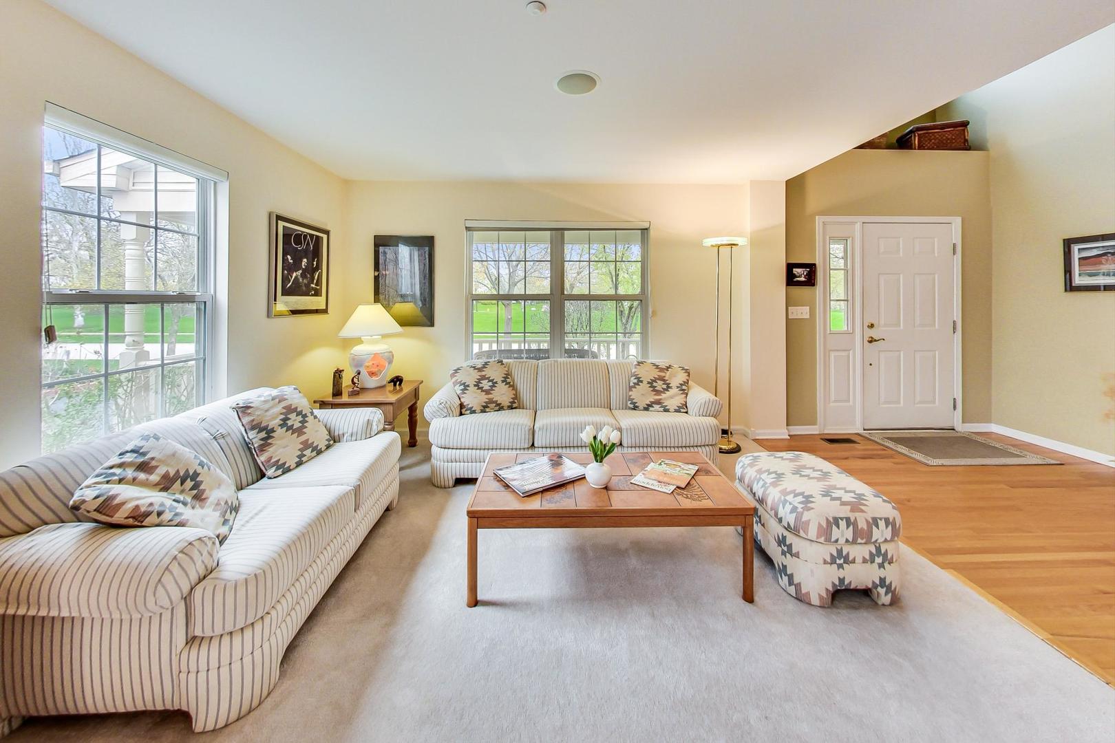 8052 Orchard Commons West Long Grove, IL 60060 - Photo 6 of 32 a bedroom with furniture and large windows