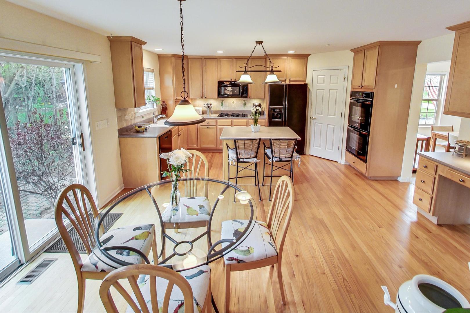 8052 Orchard Commons West Long Grove, IL 60060 - Photo 10 of 32 a view of a dining room with furniture window and wooden floor