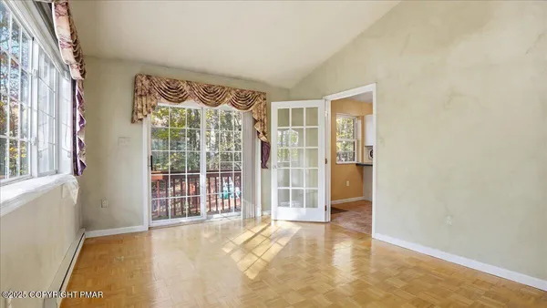 a view of living room filled with furniture and windows