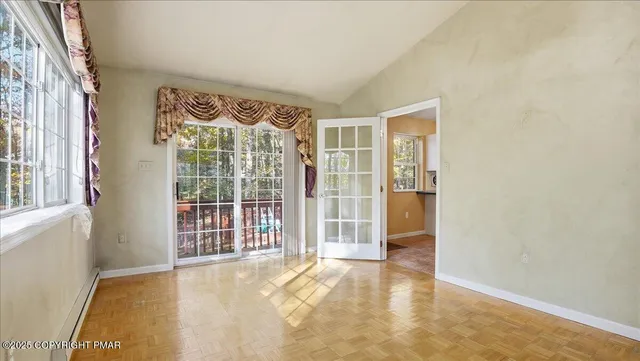a view of living room filled with furniture and windows