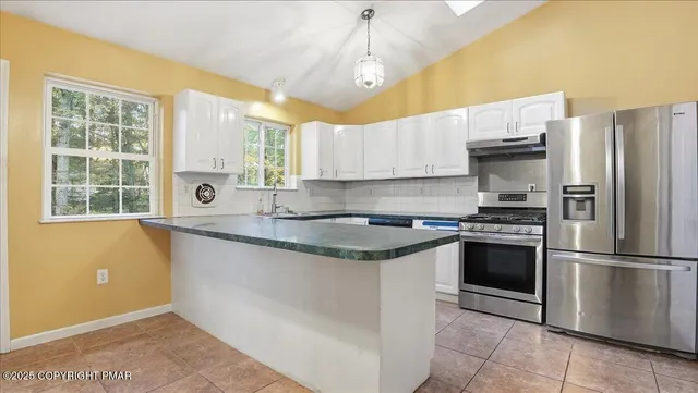 a bathroom with a granite countertop sink a toilet and a mirror