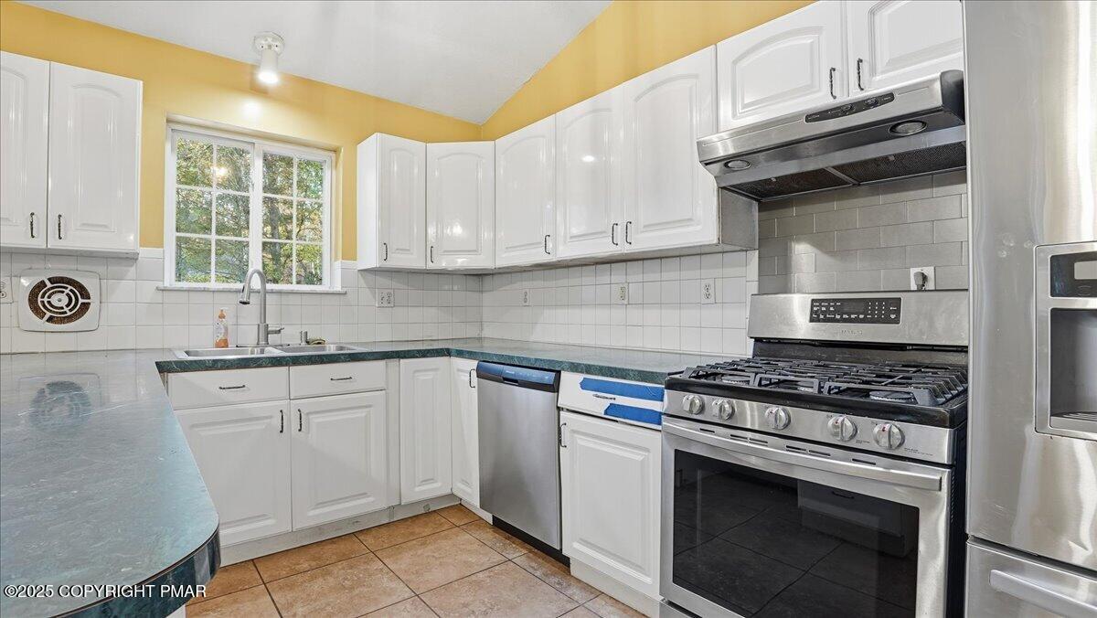 349 Bumble Bee Pass Cresco, PA 18326 - Photo 27 of 109 a kitchen with cabinets appliances a sink and a window