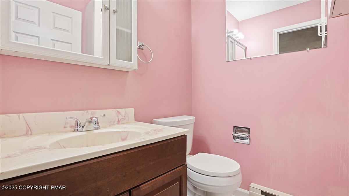 349 Bumble Bee Pass Cresco, PA 18326 - Photo 39 of 109 a bathroom with a granite countertop sink a toilet and a mirror