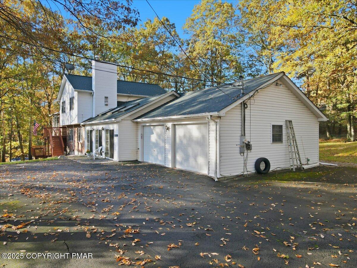 349 Bumble Bee Pass Cresco, PA 18326 - Photo 71 of 109 a view of a yard in front of a house with a large tree