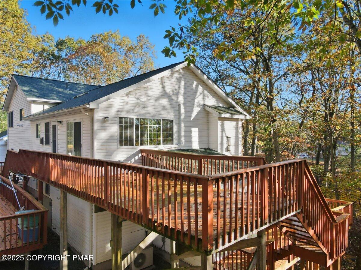 349 Bumble Bee Pass Cresco, PA 18326 - Photo 88 of 109 a view of house with a deck and a backyard