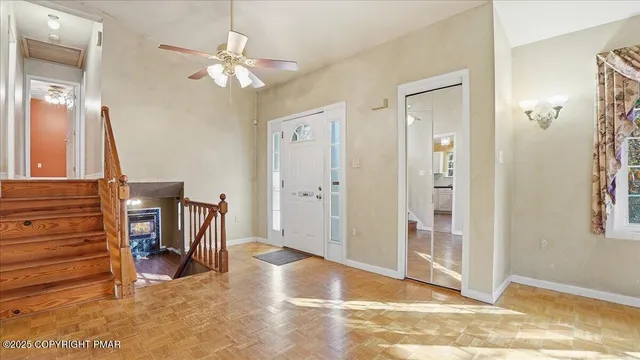 a view of an empty room with a fireplace and a window