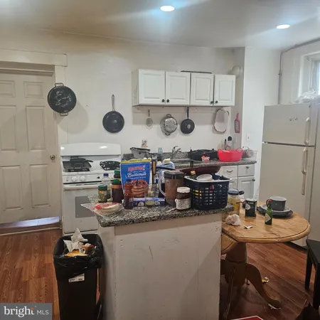 a kitchen with refrigerator and stove