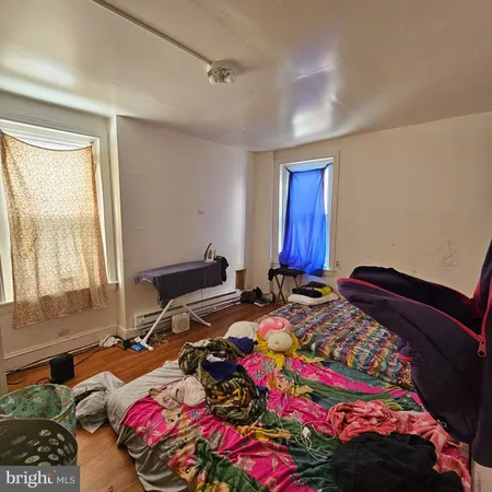 a bedroom with bed and a window