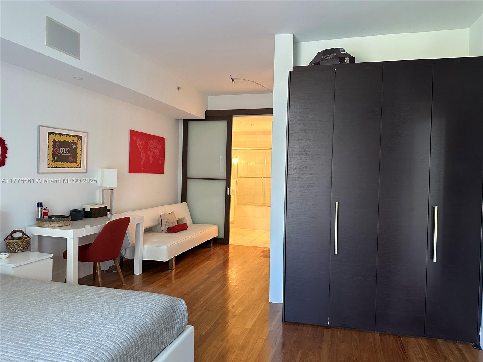 2001 Meridian Avenue, Unit 309 Miami Beach, FL 33139 - Photo 12 of 21 a bedroom with a bed and wooden floor