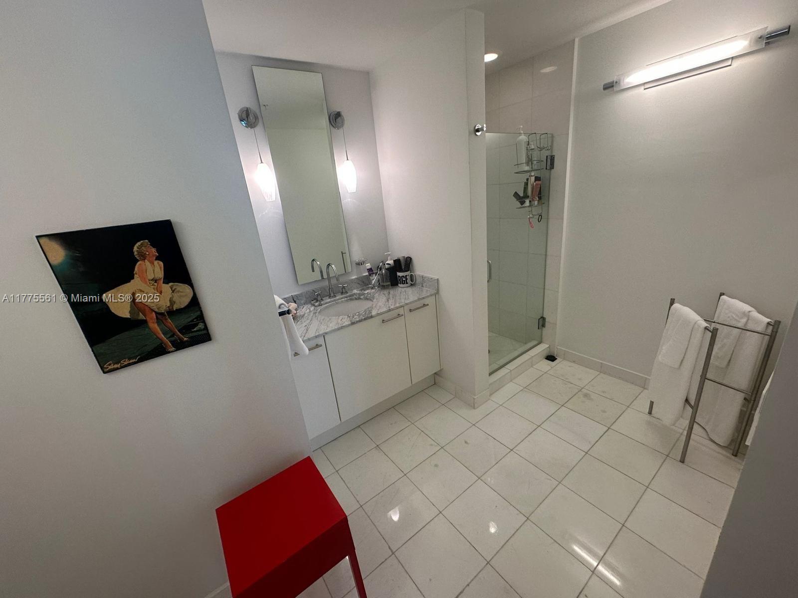 2001 Meridian Avenue, Unit 309 Miami Beach, FL 33139 - Photo 16 of 21 a bathroom with a sink a toilet and mirror