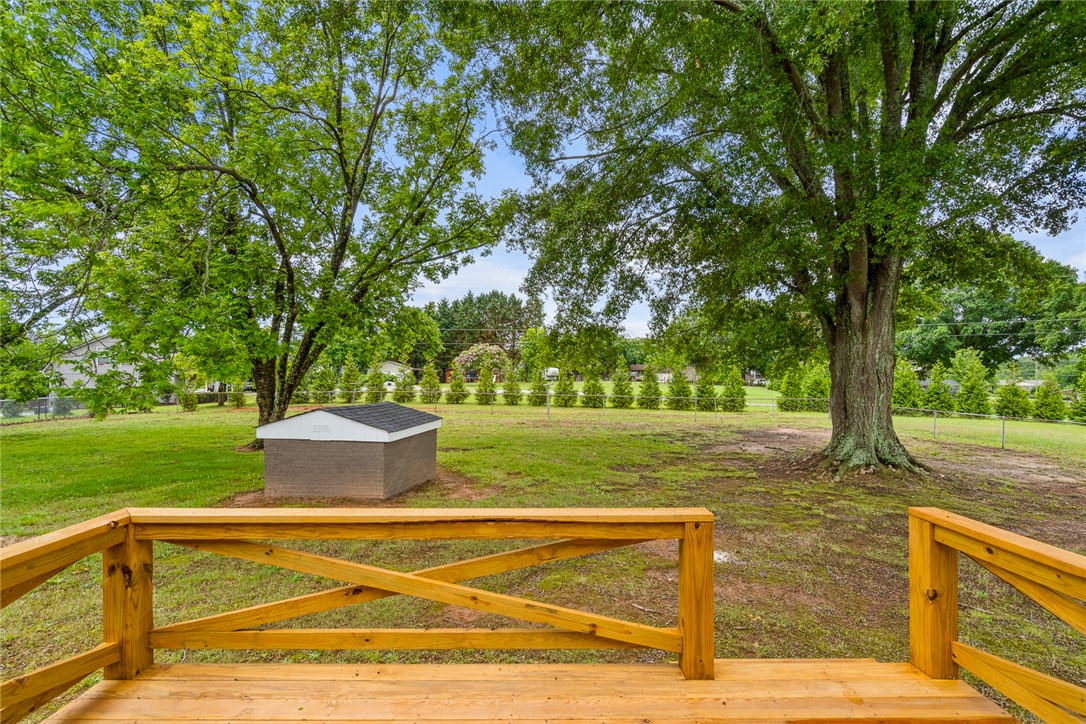300 Vandiver Road Anderson, SC 29621 - Photo 21 of 30 A spacious yard boasts mature trees, green lawn, and a quaint storage shed.
