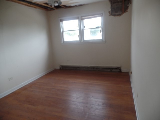 6028 South Archer Road, Unit 2 Summit, IL 60501 - Photo 2 of 6 an empty room with a window