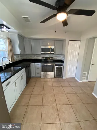 a kitchen with a stove cabinets and counter space