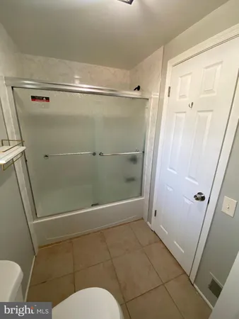 a bathroom with a glass door shower