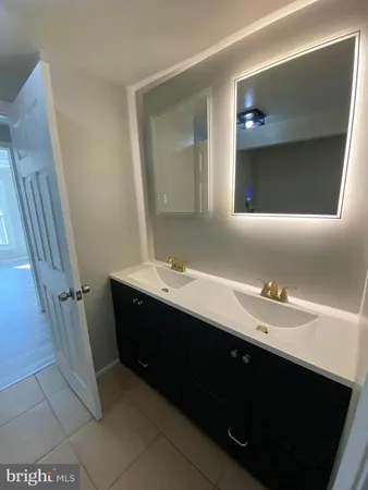 a bathroom with a sink vanity and mirror