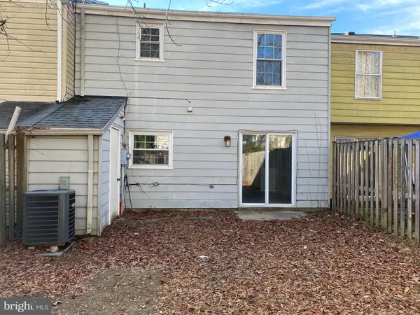 a view of backyard with wooden fence