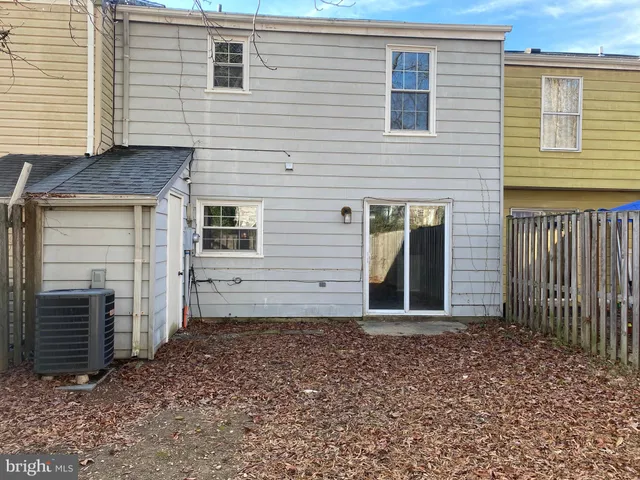 a view of backyard with wooden fence