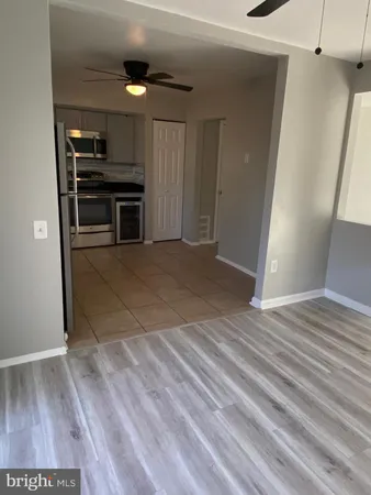 a view of empty room with wooden floor