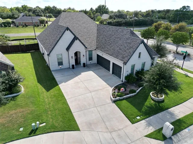 a aerial view of a house with a yard and plants