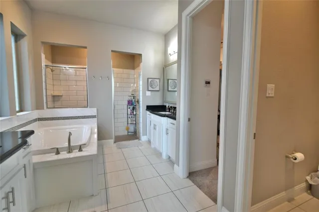 a bathroom with a granite countertop sink a toilet and a shower