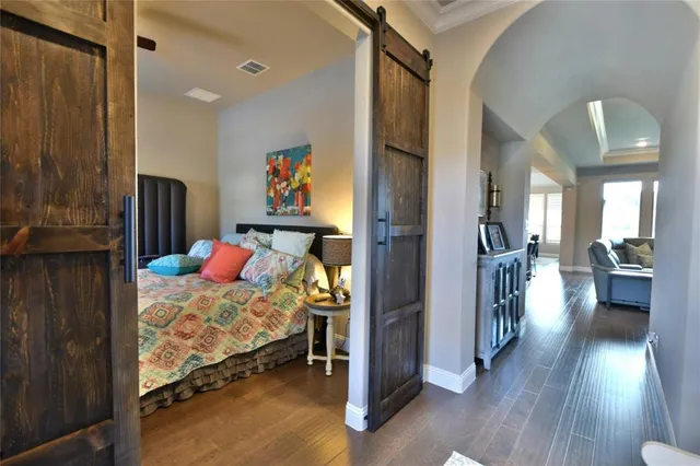 a bedroom with furniture and a wooden floor