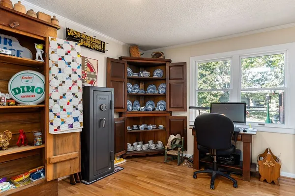 a view of a workspace with furniture and a window