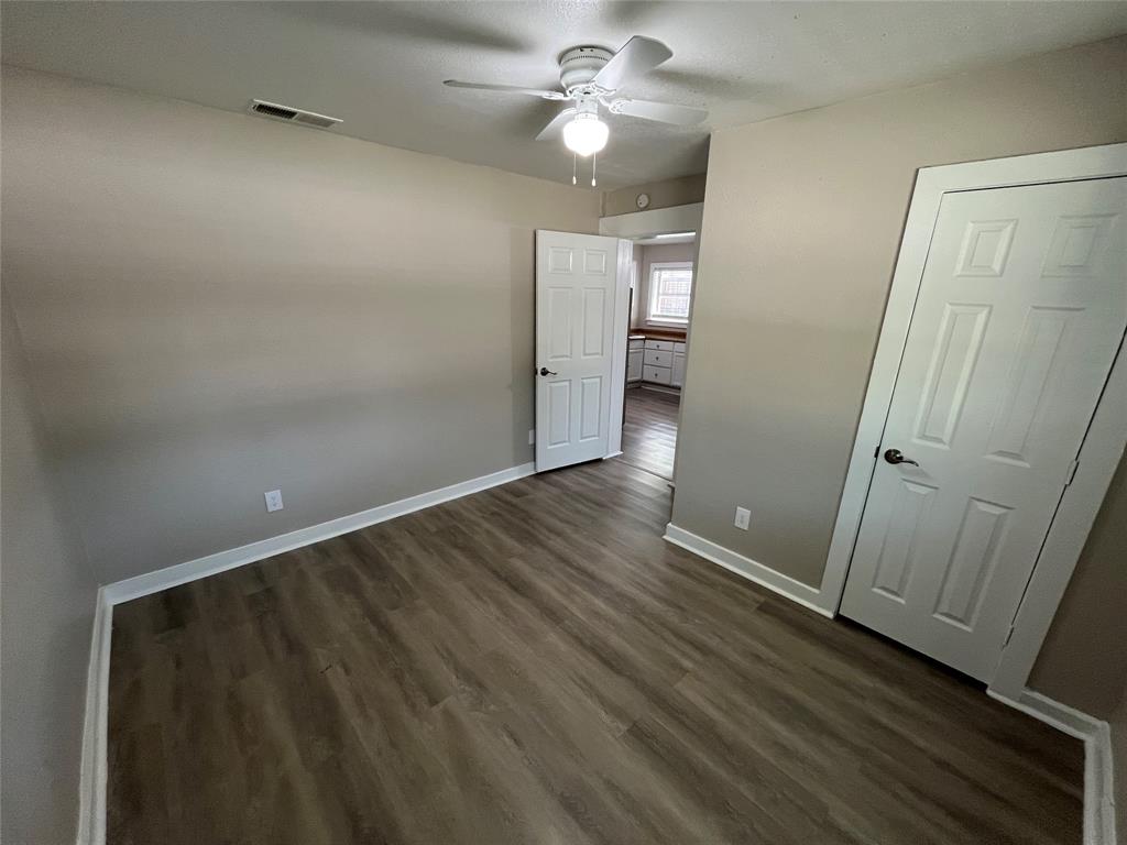 1316 North Prairie Creek Road Dallas, TX 75217 - Photo 8 of 19 Interior room featuring wood-finish flooring and neutral wall tones