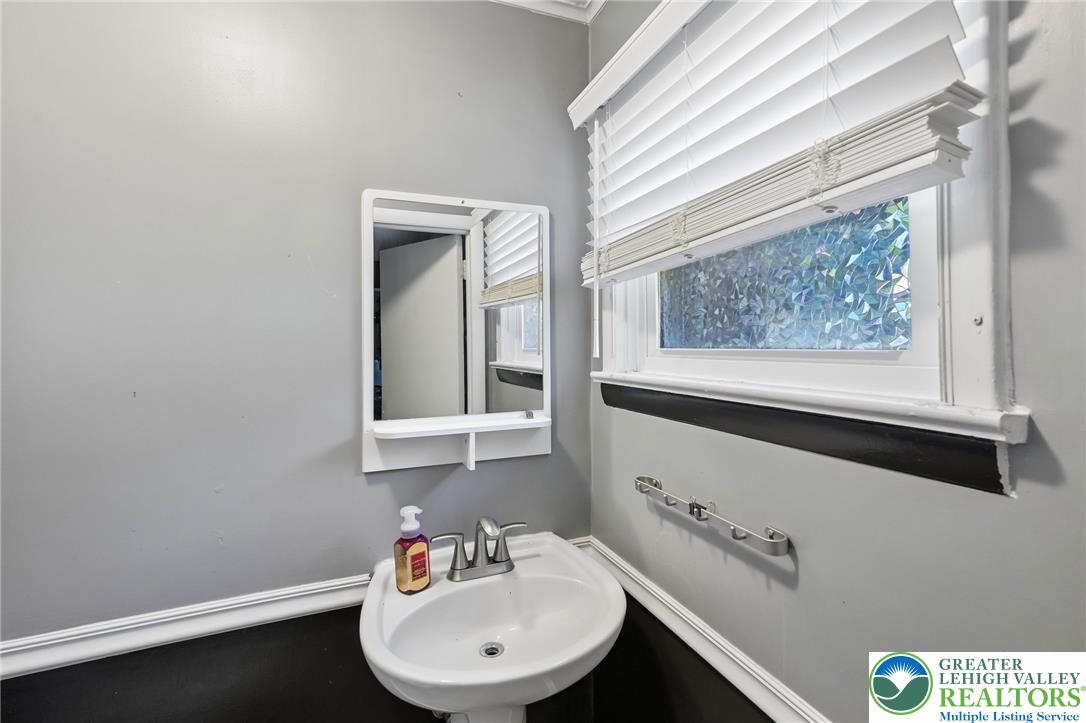 2649 Nottingham Road Bethlehem, PA 18017 - Photo 27 of 49 A compact half-bath features a clean pedestal sink and privacy window off the recreation room.
