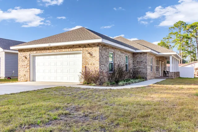 a view of a house with a yard and a garage