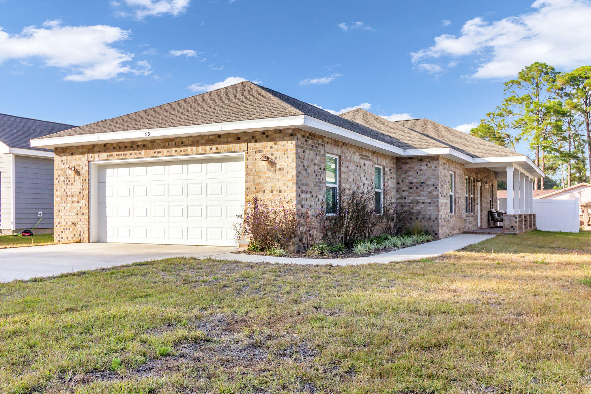 a view of a house with a yard and a garage