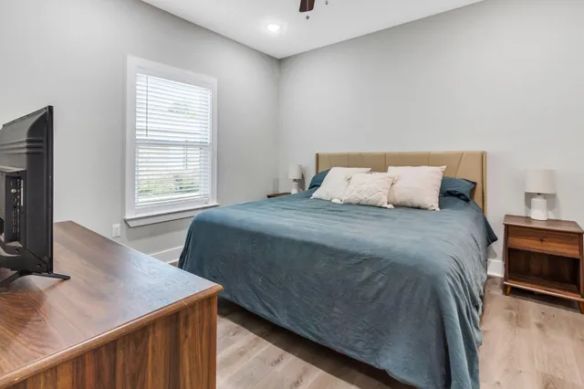 a bedroom with a bed and a flat screen tv