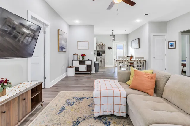 a living room with furniture and a flat screen tv