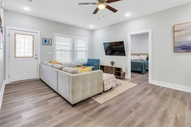 a living room with fireplace furniture and a flat screen tv