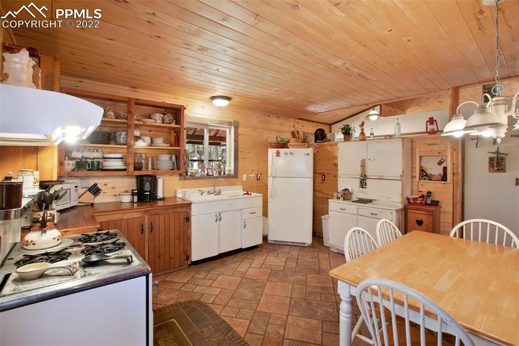 7199 Cedar Mountain Road Divide, CO 80814 - Photo 12 of 34 a kitchen with refrigerator and stove