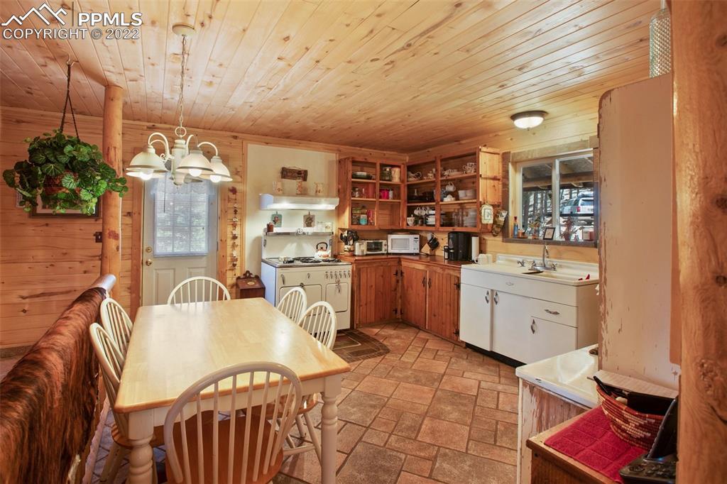 7199 Cedar Mountain Road Divide, CO 80814 - Photo 13 of 34 a kitchen with a sink appliances and cabinets