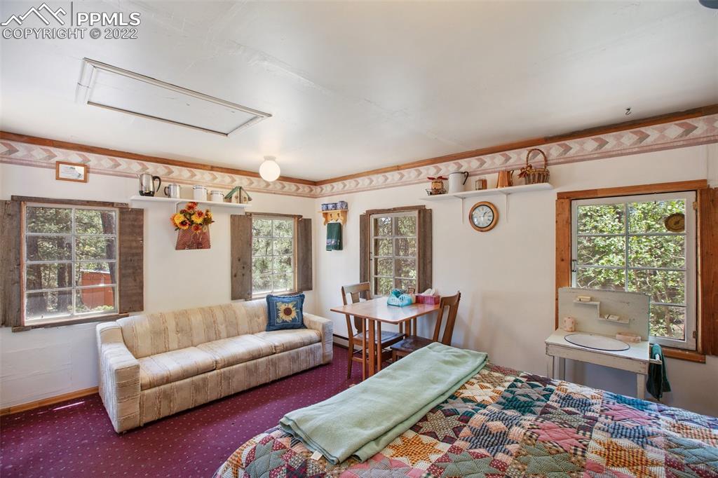 7199 Cedar Mountain Road Divide, CO 80814 - Photo 27 of 34 a living room with furniture and a large window