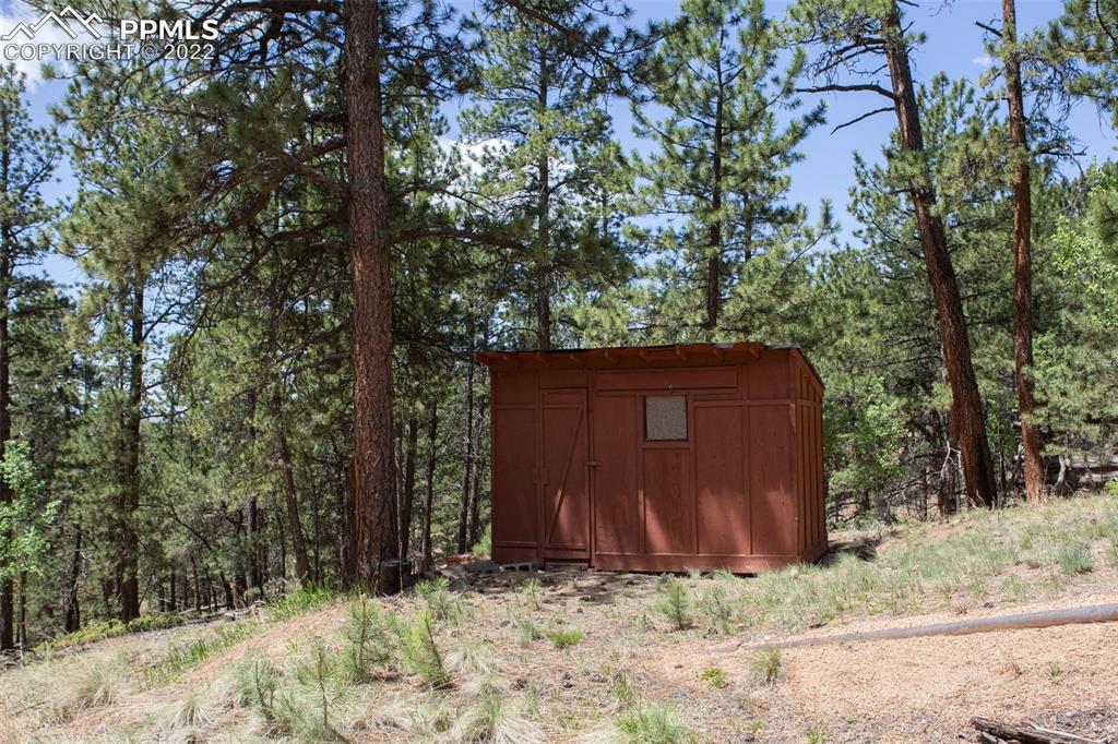 7199 Cedar Mountain Road Divide, CO 80814 - Photo 30 of 34 a view of barn with large trees