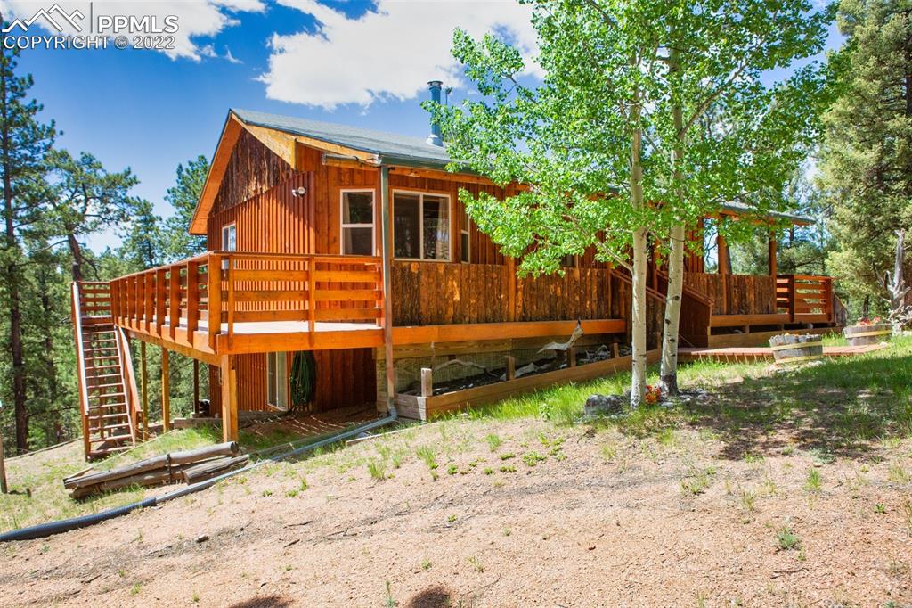 7199 Cedar Mountain Road Divide, CO 80814 - Photo 3 of 34 a front view of a house with a yard