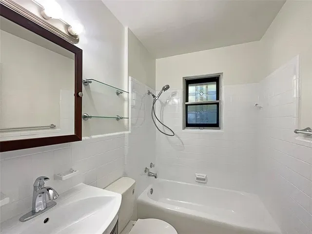 a bathroom with a bathtub a sink and a mirror