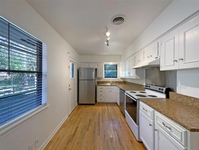 a kitchen with a stove a sink and a refrigerator