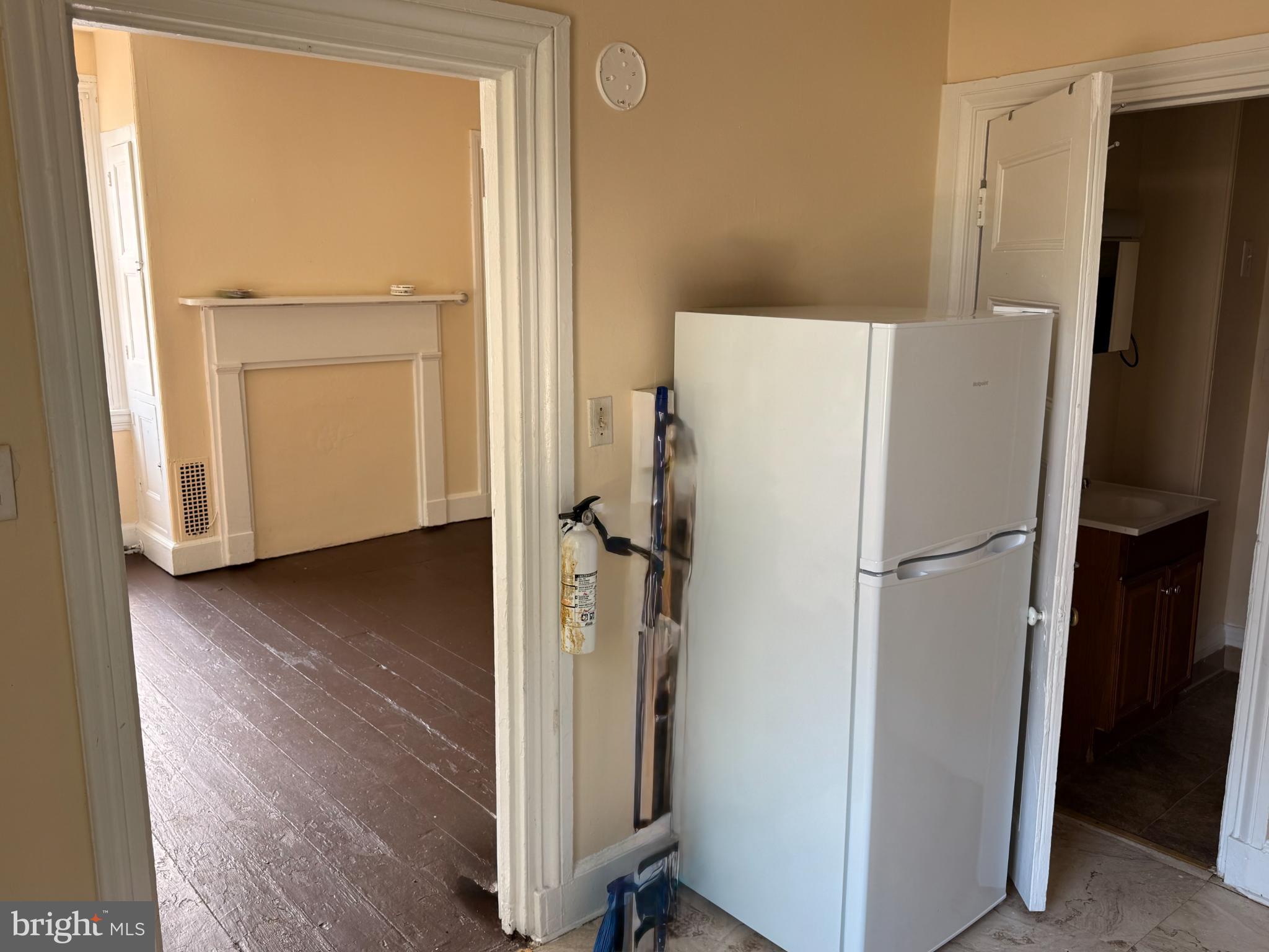 105 West Broadway, Unit C Salem, NJ 08079 - Photo 12 of 26 a white refrigerator freezer and a wooden floor