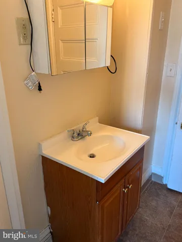 a bathroom with a sink vanity and a mirror
