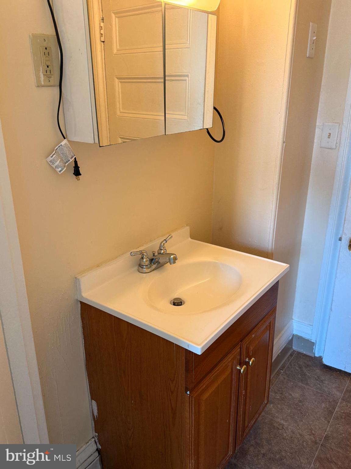 105 West Broadway, Unit C Salem, NJ 08079 - Photo 14 of 26 a bathroom with a sink vanity and a mirror