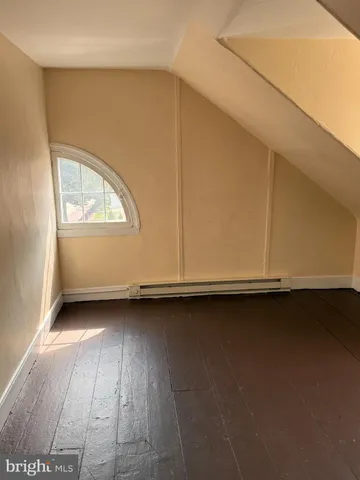 a view of a room with wooden floor and window