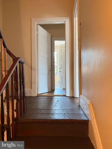 a view of hallway with wooden floor