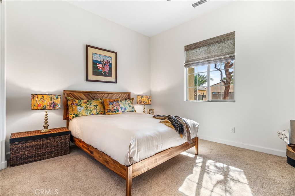 82 Prosecco Rancho Mirage, CA 92270 - Photo 25 of 56 a bedroom with a bed and window