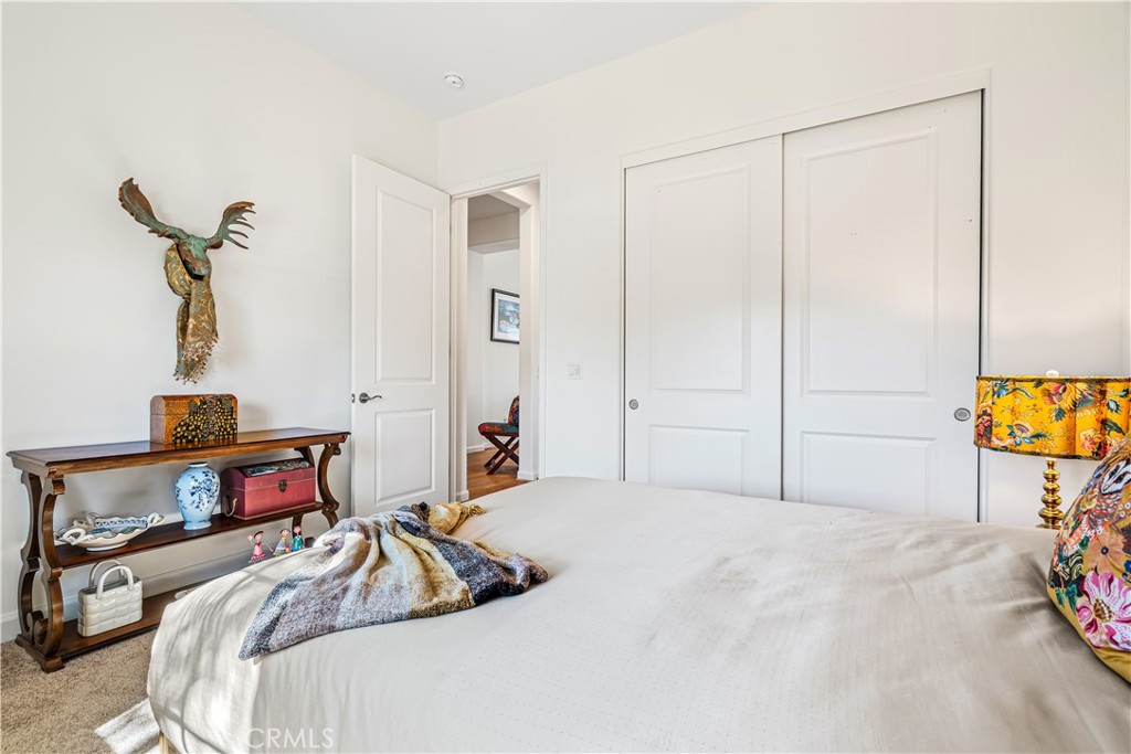 82 Prosecco Rancho Mirage, CA 92270 - Photo 27 of 56 a bedroom with a bed and a dresser in it