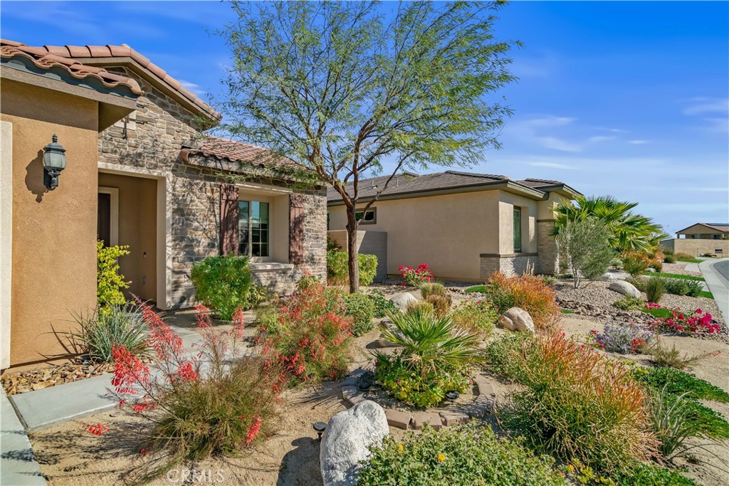82 Prosecco Rancho Mirage, CA 92270 - Photo 3 of 56 a view of a house with a flower garden